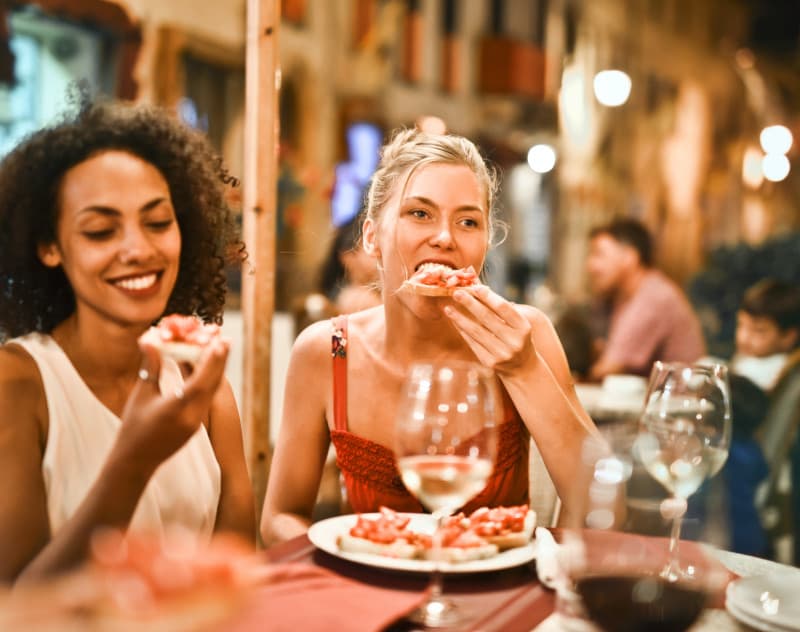 Women eating pizza by Adrienn on Pexel