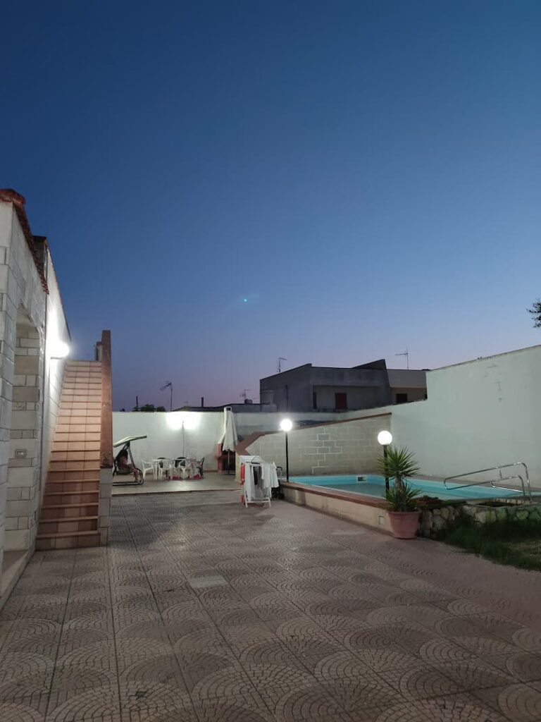 Swimming pool and garden in our villa by night