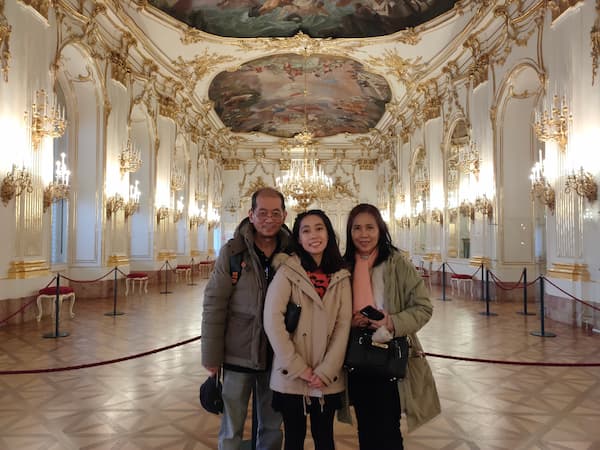 Family picture taken at one of the room at Schonbrunn palace, Vienna